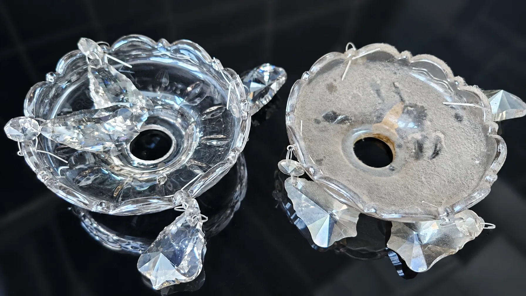 Two ornate scalloped glass chandelier bobeche drip pans side by side, one dulled with dust and grime and one clean and bright following specialist cleaning