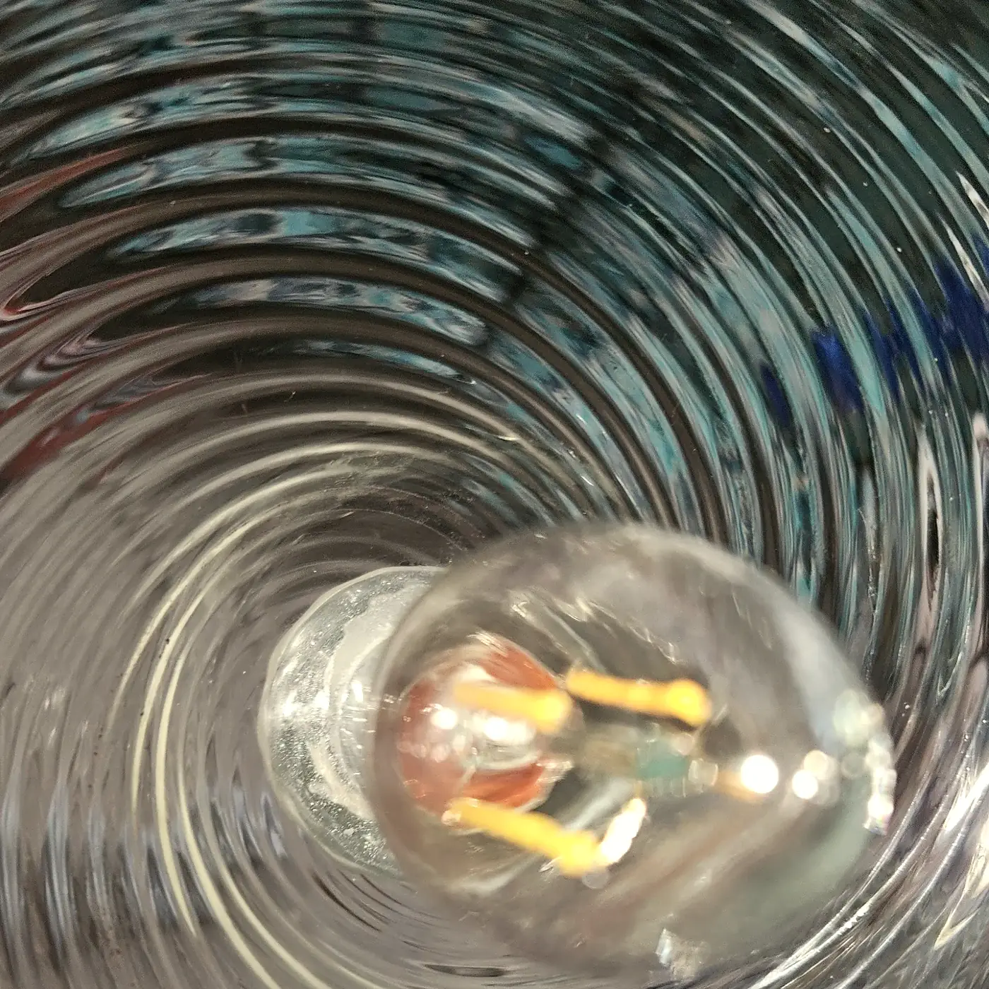 Clean ribbed hand-blown glass shade with a filament bulb